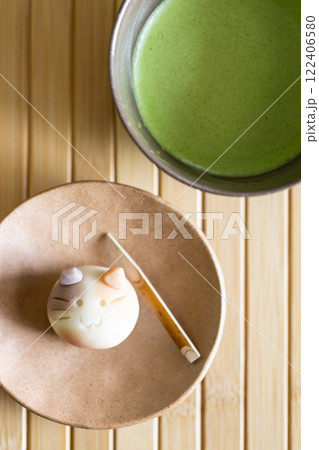 Fresh matcha drink in traditional ceramic bowl with traditional Japanese confectionery. 122406580