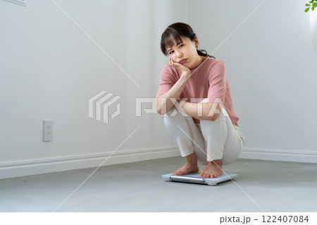 体重計に乗ってがっかりする女性 体重計に乗ってがっかりする女性 122407084