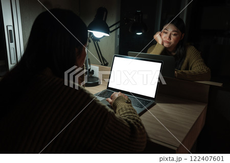 bored woman working with laptop at night (with clipping path) 122407601