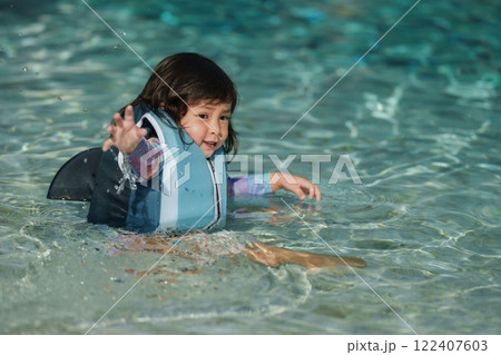 happy toddler baby girl in life jacket playing water splashing in swimming pool happy toddler baby girl in life jacket playing water splashing in swimming pool 122407603