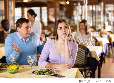 Man having quarrel with his girlfriend in restaurant Man having quarrel with his girlfriend in restaurant 122408400