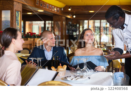 Young adult friends making order at restaurant 122408568