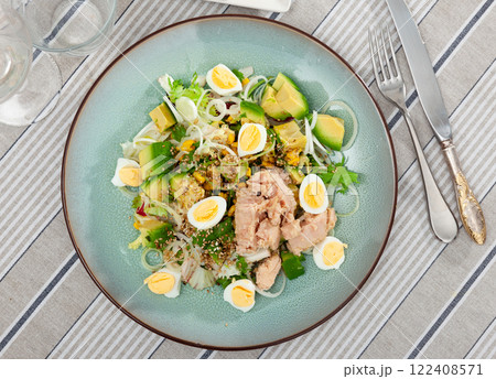 Salad of fresh ripe avocado with boiled eggs, sesame seeds, tuna and chopped onions, dressed with oil Salad of fresh ripe avocado with boiled eggs, sesame seeds, tuna and chopped onions, dressed with oil 122408571