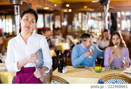 Portrait of upset waitress in the hall of restaurant Portrait of upset waitress in the hall of restaurant 122408661