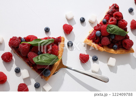 Pieces of berry pie, sugar and berries on white background, top view 122409788