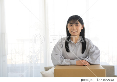段ボール箱に肘をつく女性 段ボール箱に肘をつく女性 122409938