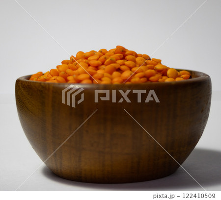 Wooden bowl with turkish lentils ,isolated with white background. Wooden bowl with turkish lentils ,isolated with white background. 122410509