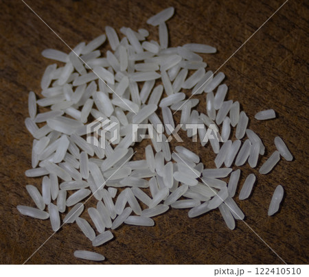 White rice isolated in wooden dark bacground. White rice isolated in wooden dark bacground. 122410510