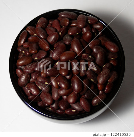 Black beans in black bowl isolated on white background  122410520