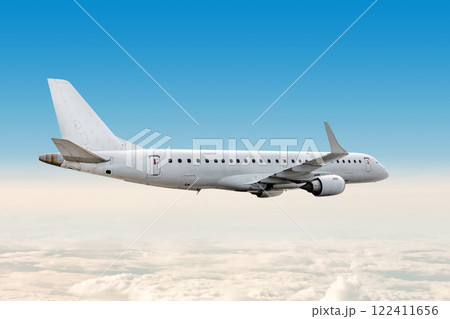 White passenger airliner flying in the air above the clouds 122411656