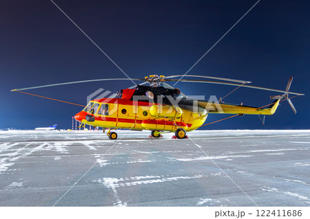 Medical helicopter on winter airport apron at night Medical helicopter on winter airport apron at night 122411686