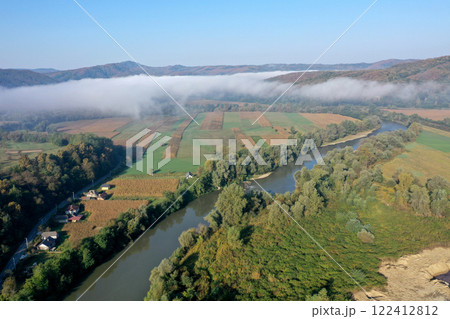 Aerial view of quiet river and forest in a misty morning Aerial view of quiet river and forest in a misty morning 122412812