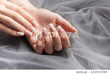 Woman showing stylish trendy female manicure on gray background 122413564