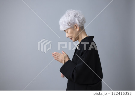 喪服を着て手を合わせているシニア女性 喪服を着て手を合わせているシニア女性 122416353