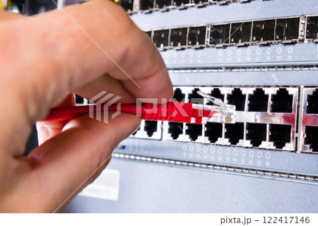 hand with red ethernet cable hand with red ethernet cable 122417146