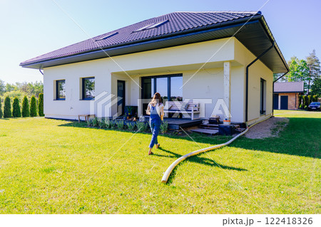 Young woman gardener wears jeans overalls going to new home. Leisure, lifestyle, mental health, real life concept. 122418326