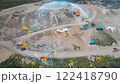 aerial view shot mining, dumpers, quarrying extractive industry stripping work. Big Mining Trucks. View from drone at opencast mining with lots of machinery trucks. High quality photo 122418790