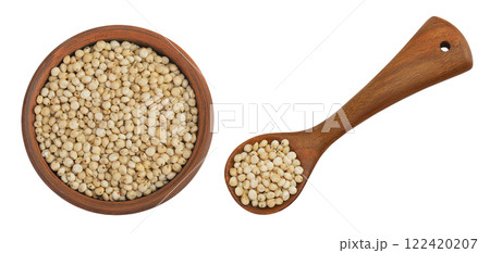 Sorghum seeds in ceramic bowl and wooden spoon isolated on white background. Top view. Flat lay. 122420207