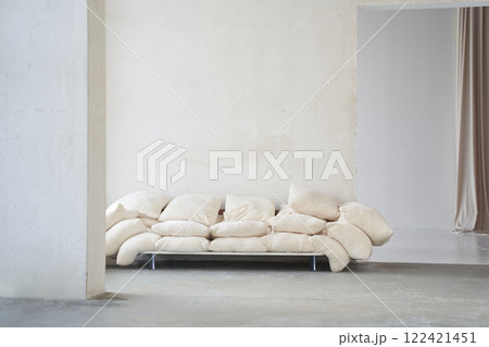 In the foreground of the wall is a creative composition of the living room interior with an uneven sofa made of pillows in a modern style. Home decor. With space to copy. High quality photo 122421451