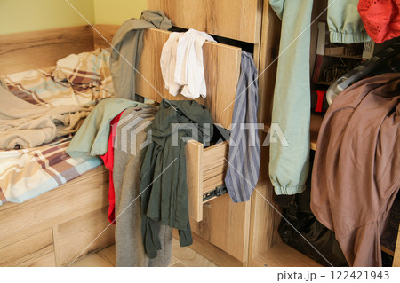 Scattered Things in Wardrobe, Disorder in Clothes. Childrens room is littered with clutter 122421943