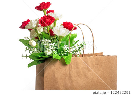 Bouquet of beautiful red and white roses in a paper bag on a white background, Closeup Bouquet of beautiful red and white roses in a paper bag on a white background, Closeup 122422291