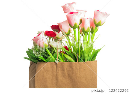 Beautiful bouquet of artificial flowers in a brown paper bag on a white background, copy space Beautiful bouquet of artificial flowers in a brown paper bag on a white background, copy space 122422292