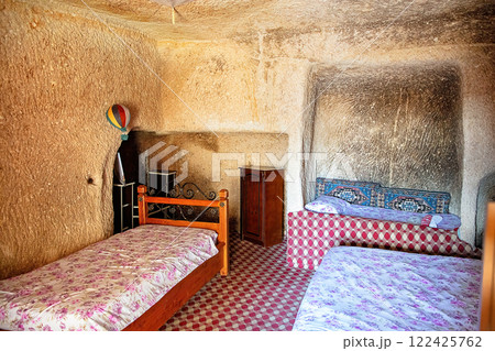 Unique cave dwelling with cozy bedding in Cappadocia's magical landscape Unique cave dwelling with cozy bedding in Cappadocia's magical landscape 122425762