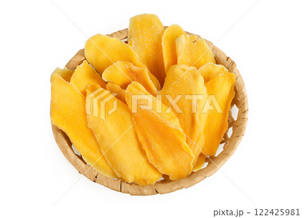dried mango in a wicker basket isolated on white background. Top view. Flat lay. 122425981