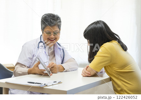 Depressed asian girl having consultation with psychologist at clinic. Depressed asian girl having consultation with psychologist at clinic. 122426052