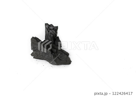 Isolated pieces of black charcoal resting on a clean white background, showcasing its rough texture and deep, rich color. Often used for grilling, art, and filtration, charcoal symbolizes both energy Isolated pieces of black charcoal resting on a clean white background, showcasing its rough texture and deep, rich color. Often used for grilling, art, and filtration, charcoal symbolizes both energy 122426417