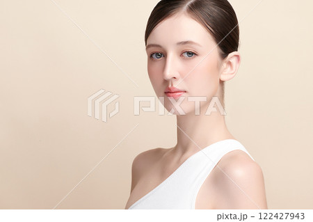 Beautiful young woman with clean fresh skin on beige background, Face care, Facial treatment, Cosmetology, beauty and spa, women portrait. 122427943