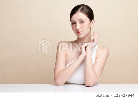 Beautiful young woman with clean fresh skin on beige background, Face care, Facial treatment, Cosmetology, beauty and spa, women portrait. 122427944