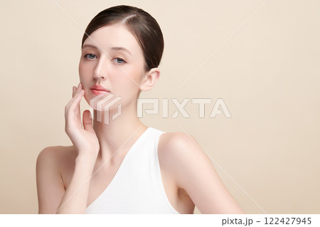 Beautiful young woman with clean fresh skin on beige background, Face care, Facial treatment, Cosmetology, beauty and spa, women portrait. 122427945