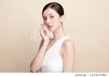 Beautiful young woman with clean fresh skin on beige background, Face care, Facial treatment, Cosmetology, beauty and spa, women portrait. 122427946