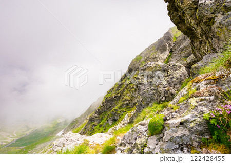 steep slope of fagaras ridge. high altitude. mountain landscape of romania in summer. distant valley in clouds. stunning country ecosystem 122428455