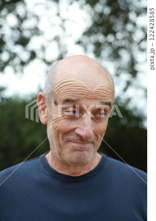 Smiling Elderly Man Says Yes Slyly In Countryside Near Trees 122428585