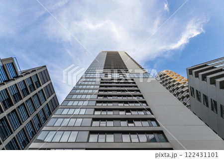 Skyscraper Perspective. Tall Modern Building with Glass and Concrete Skyscraper Perspective. Tall Modern Building with Glass and Concrete 122431101