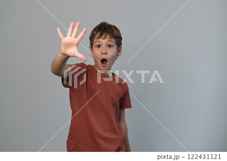Child s expression of mock terror, eyes widened, mouth open, captures a moment of fun. Highlights how simple actions can evoke laughter and happiness. Child s expression of mock terror, eyes widened, mouth open, captures a moment of fun. Highlights how simple actions can evoke laughter and happiness. 122431121