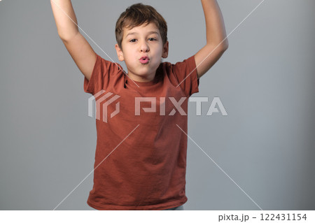 Youngster dramatizes a scare, stretching his eyes in jest. Emphasizes the importance of creativity in youth development and stress relief. Youngster dramatizes a scare, stretching his eyes in jest. Emphasizes the importance of creativity in youth development and stress relief. 122431154