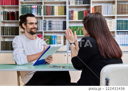 Young male mental health specialist working with mature female patient 122431436