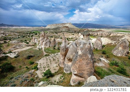 Unique rock formations rise majestically under a dramatic sky in a scenic landscape Unique rock formations rise majestically under a dramatic sky in a scenic landscape 122431781