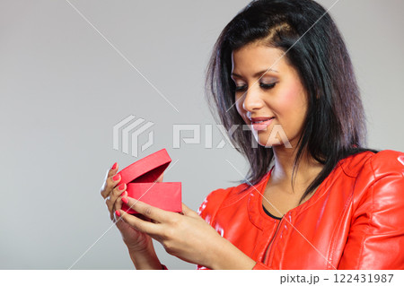 Girl in red holding heart gift Girl in red holding heart gift 122431987