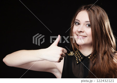 teen girl giving thumbs up sign on black 122432121