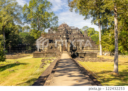 An ancient temple, resplendent and majestic, is beautifully surrounded by lush greenery and trees 122432253