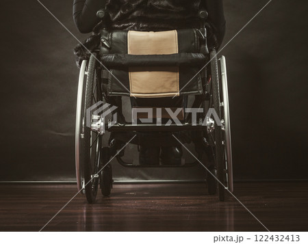 Girl sitting on wheelchair. 122432413