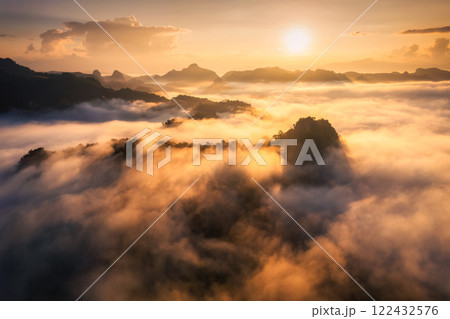 Golden sunrise over foggy mountain in valley at Ban Jabo tribe village Golden sunrise over foggy mountain in valley at Ban Jabo tribe village 122432576