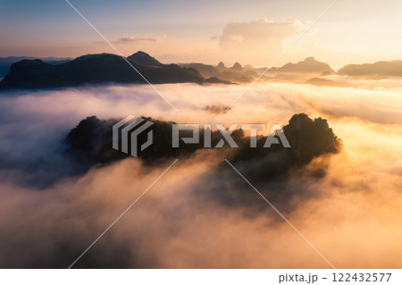 Golden sunrise over foggy mountain in valley at Ban Jabo tribe village 122432577