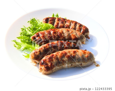 Grilled meat sausages on green salad leaves 122433395