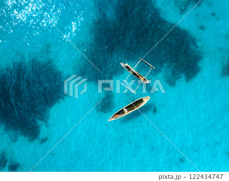 Aerial drone view of the speed boat in clear blue sea in summer Aerial drone view of the speed boat in clear blue sea in summer 122434747