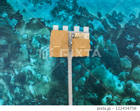 Aerial view of bungalow, jetty, white sandy beach, blue sea 122434756